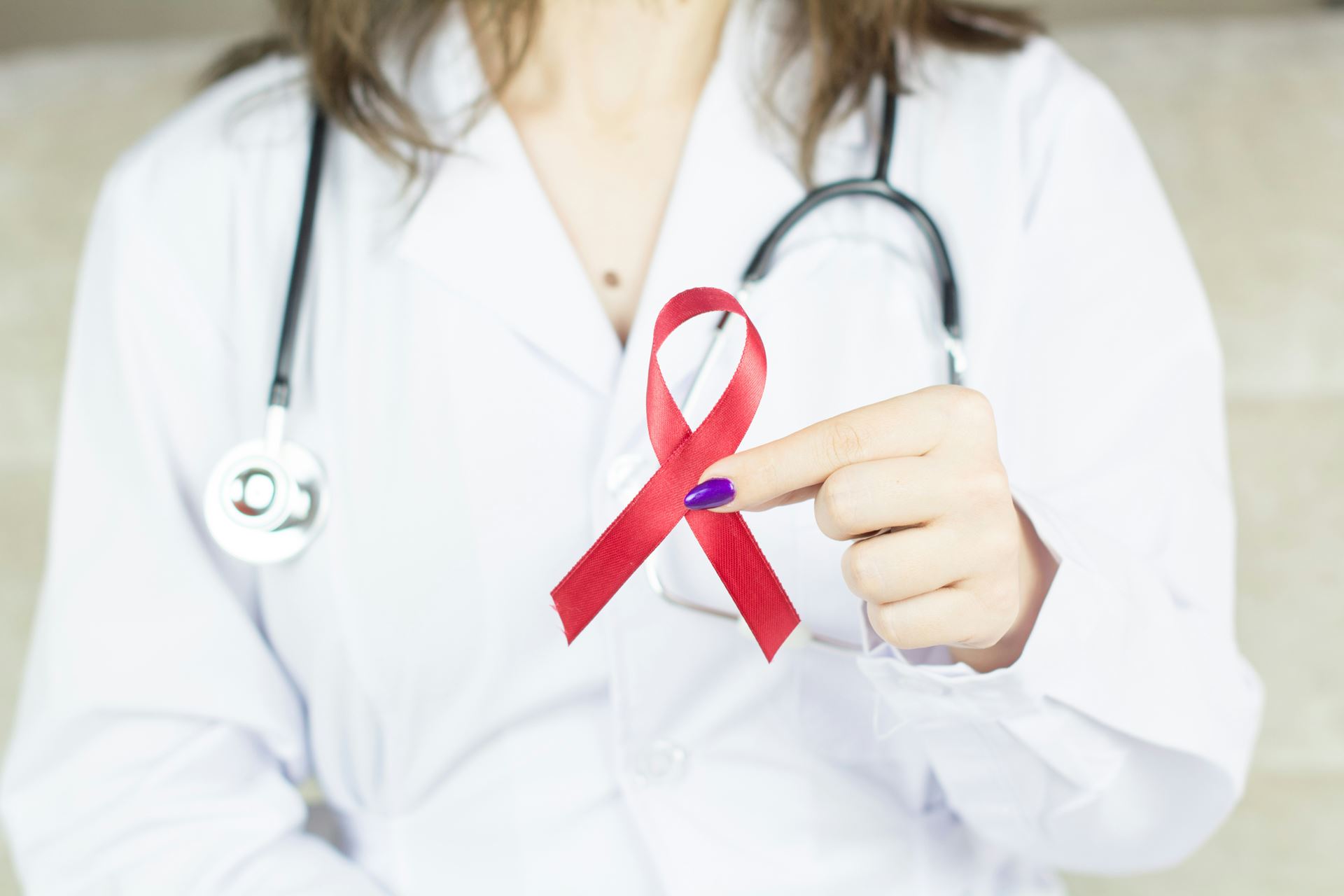 cancer awareness ribbon in doctors hand